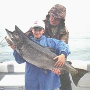 Pictured here is 14 year old Bobby Moore of Sayre, P.A. with a thirty four pound King Salmon caught from Lake Ontario. This fantastic salmon was  caught in late July 2003 fishing with Dave Johnson of  Silver Bear Sports