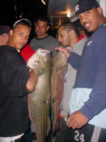 Pictured here is Carlos Ortiz with a rather large striped bass that he caught while fishing on the Island Current Party Boat