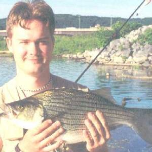 gordon bennett with a hybrid striped bass