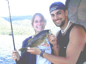 Pictured here is Allison Wagner and Brian Brodman of Queens, NY. Brian is holding a feisty smallmouth bass that was caught from Lake George in August 2003. The smallmouth bass was caught with a minnow while fishing from a boat