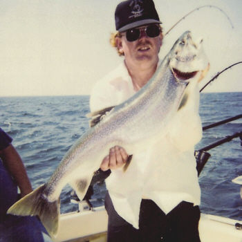 Raymond Martin of Elmira, N.Y. with a huge lunker lake trout. This one weighed 14 pounds and was caught about 8 miles off shore from Point Breeze in Lake Ontario