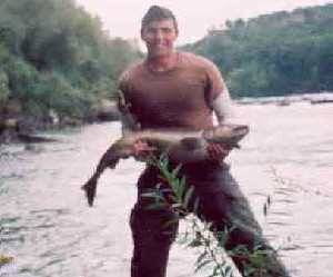 Patrick Herbert of Buffalo NY is pictured  holding his first salmon ever.  He was fishing at the Devils Hole on the lower Niagara River