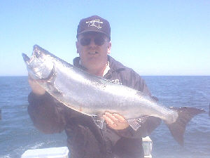 Raymond Martin of Elmira, NY is pictured here with a 19 pound King Salmon caught from Lake Ontario on June 30, 2003. He was fishing in the 1000 Dollar A Day Derby