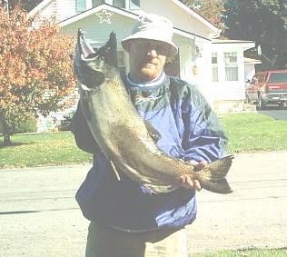 Tim Swank from Elmira , NY decided to take a fishing trip to the Oak Orchard. He was fishing below the dam and caught this nice salmon in a small hole on the side of the falls. This was his first ever salmon and now has a big case of salmon fever.