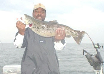 Reginald Johnson from Philadelphia PA. He is holding a fabulous 12 pound brown that he trout caught on the Buc-A-Roo while fishing for salmon in August 2004.